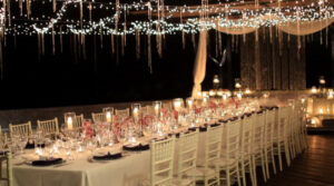 Beautiful wedding table decor idea with battery operated candles, orchids and crystals.